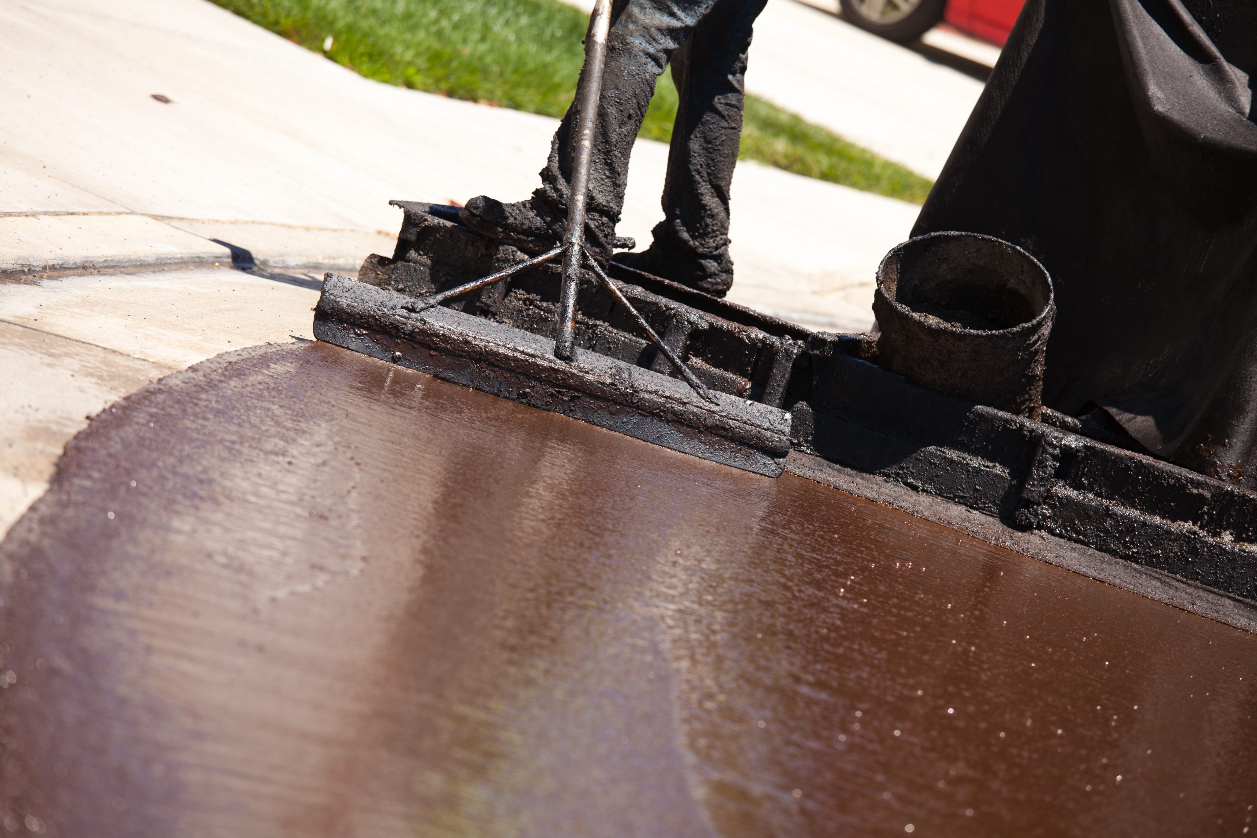 Road Worker Resurfacing Street with Hot Tar.