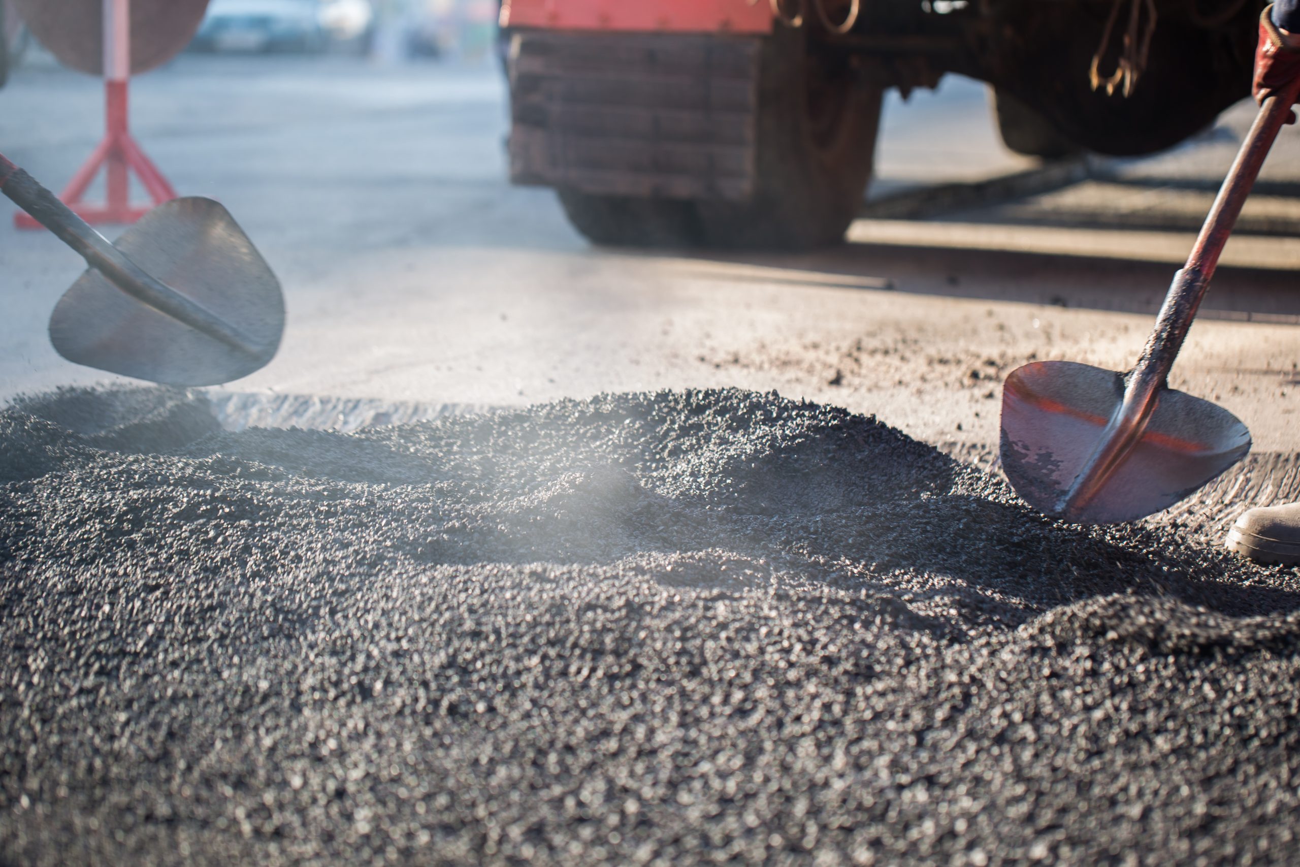 Street resurfacing. Fresh asphalt construction. Bad road